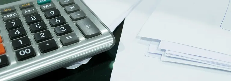 a stack of papers on a clipboard shows relevant website statistics