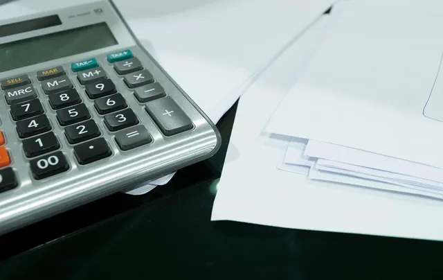 a stack of papers on a clipboard shows relevant website statistics
