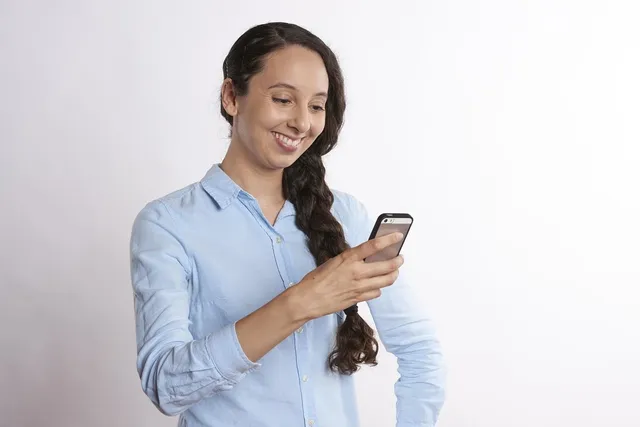 Happy business woman with a mobile phone