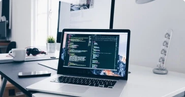 Laptop with website coding on its screen