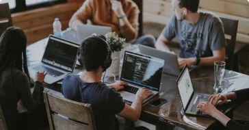 Team of developers with their laptops
